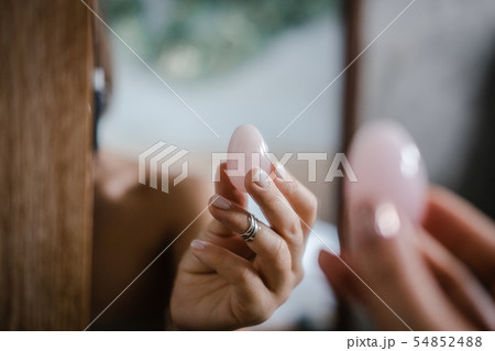 Woman holds yoni egg in hand 54852488