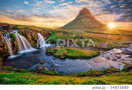Beautiful landscape with sunrise on Kirkjufellsfoss waterfall and Kirkjufell mountain, Iceland. 54853680