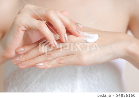 Woman applying moisturizing cream/lotion on hands. Woman applying moisturizing cream/lotion on hands. 54856160