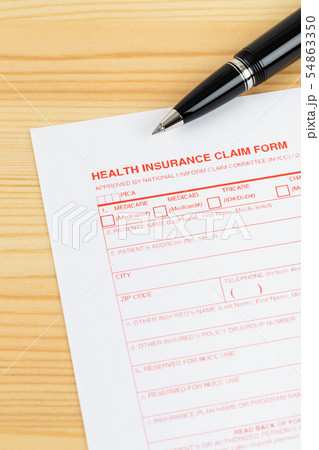 Health insurance claim form with pen on wooden Health insurance claim form with pen on wooden 54863350