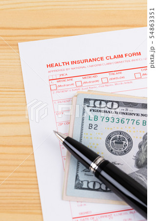Health insurance claim form with pen on wooden Health insurance claim form with pen on wooden 54863351