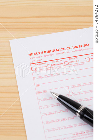 Health insurance claim form with pen on wooden Health insurance claim form with pen on wooden 54864232