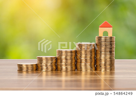 Mini model house on coins stack concept for 54864249