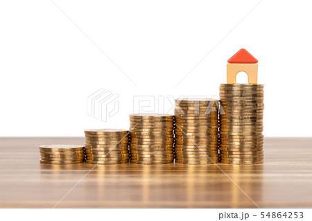 Mini model house on coins stack concept for 54864253