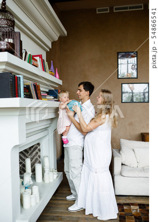 Tender family hugs. Happy pregnant mom, dad holds the baby in his arms at home 54866541