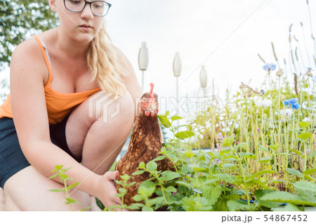 A girl and her chicken A girl and her chicken 54867452