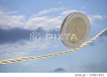 2 Euro cent coin balancing on golden rope 54867663