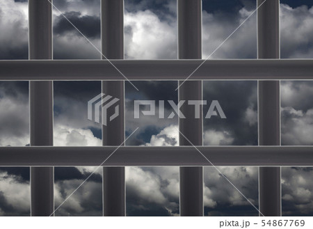 Prison window cell and cloudy sky 54867769