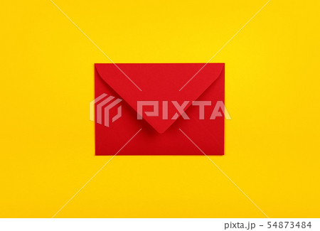 Closed red paper envelope over yellow Closed red paper envelope over yellow 54873484