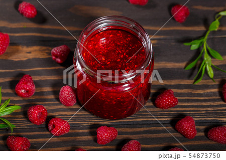 Jar of jam and ripe raspberry berries 54873750