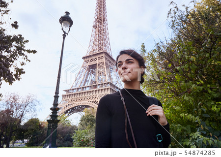 Beautiful smiling girl posing on the background of the Eiffel Tower. Paris, Champ de Mars 54874285