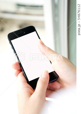 Woman with modern mobile phone in hands touching 54876112