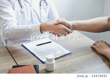 Doctor having shaking hands to congrats with Doctor having shaking hands to congrats with 54876692