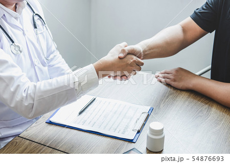 Doctor having shaking hands to congrats with Doctor having shaking hands to congrats with 54876693