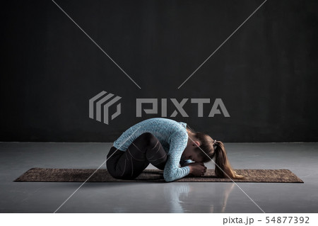 woman doing yoga or pilates butterfly exercise, sitting in baddha konasana woman doing yoga or pilates butterfly exercise, sitting in baddha konasana 54877392