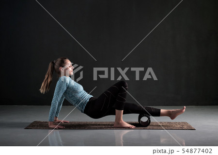Woman uses foam roller to remove pain, stretch and massage muscles of legs. Woman uses foam roller to remove pain, stretch and massage muscles of legs. 54877402