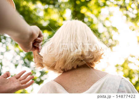 Woman doing an haircut to her grandmother 54877422