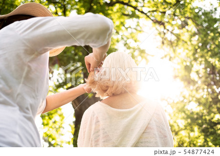 Woman doing an haircut to her grandmother 54877424