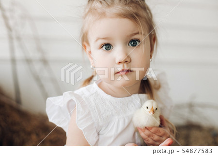 Lovely girl with big beautiful eyes keeping little Lovely girl with big beautiful eyes keeping little 54877583