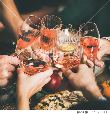 Friends clinking glasses with rose wine at 54878741