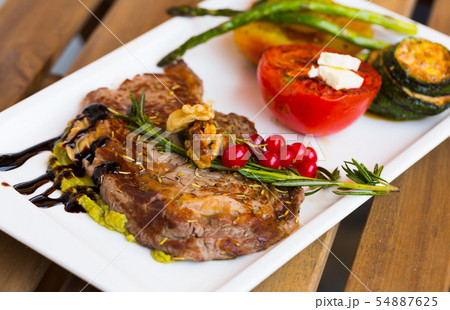 Veal with baked vegetables is tasty dish 54887625
