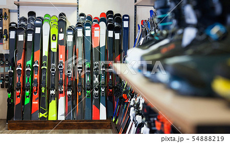 Variety of alpine skis for sale in modern sports equipment store Variety of alpine skis for sale in modern sports equipment store 54888219