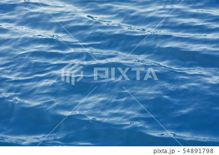 Shining blue wavy water surface ripple background Shining blue wavy water surface ripple background 54891798