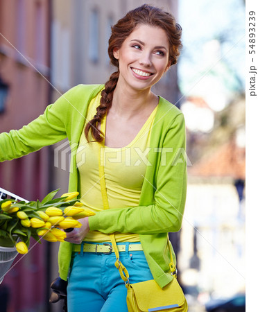 Fashionable woman with a bicycle on the streets of 54893239