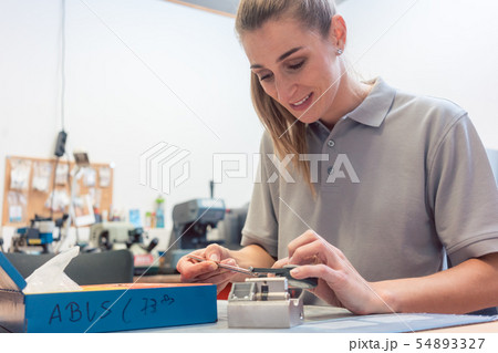 Woman locksmith repairing a lock 54893327