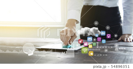 Businesswoman analyzing graph on digital tablet Businesswoman analyzing graph on digital tablet 54896351