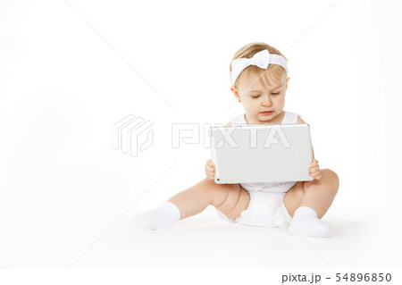little girl all in white with a tablet 54896850