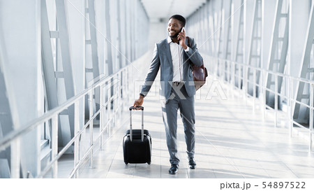 Busy Businessman Traveller Talking on Phone, Walking Inside Airport 54897522