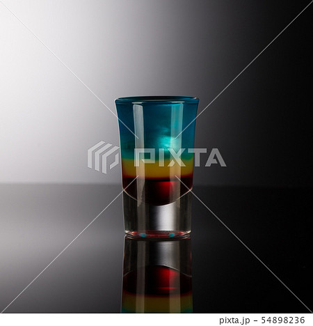 shot glass with alcohol on a dark background 54898236