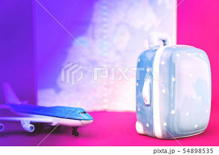 Pink violet aircraft and suitcase travel concept Pink violet aircraft and suitcase travel concept 54898535