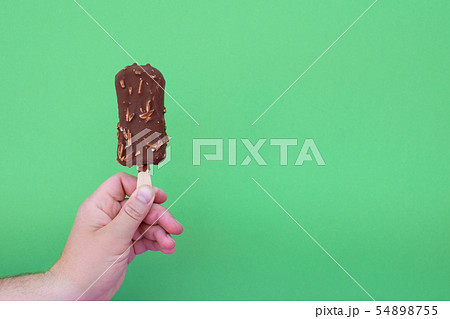 Ice cream in a hand of man. Ice cream in a hand of man. 54898755