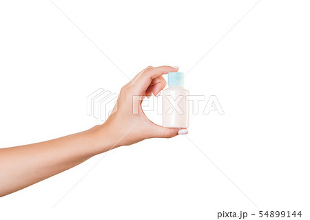 Female hand holding cream bottle of lotion 54899144