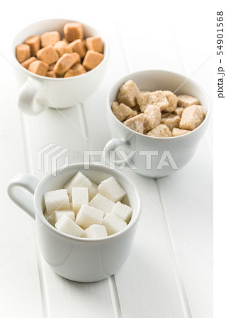 White and brown sugar cubes. White and brown sugar cubes. 54901568