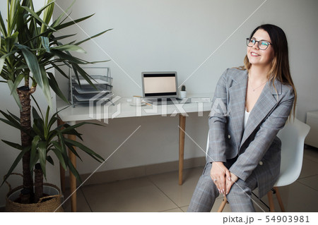 younger girl working in the office at the table 54903981