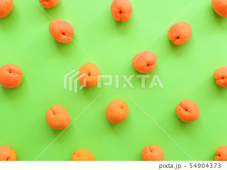 Apricot on bright green background. Apricots Apricot on bright green background. Apricots 54904373