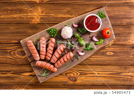Fried sausages with herbs , spices and ketchup 54905473