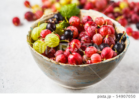 Red, green and black gooseberries in a bowl Red, green and black gooseberries in a bowl 54907050