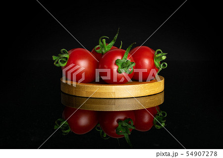 Red cherry tomato isolated on black glass 54907278