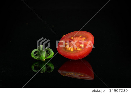 Red cherry tomato isolated on black glass 54907280
