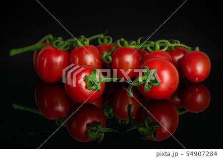 Red cherry tomato isolated on black glass 54907284