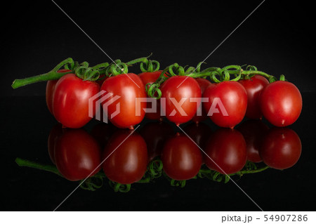 Red cherry tomato isolated on black glass 54907286