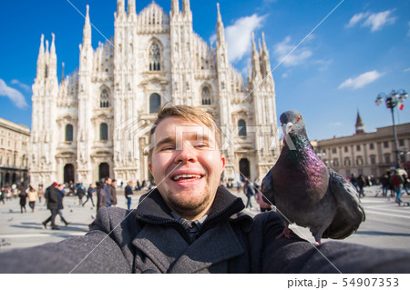 Travel, holidays and winter vacations concept - Happy man take selfie photo with funny pigeons in Travel, holidays and winter vacations concept - Happy man take selfie photo with funny pigeons in 54907353