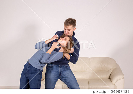 people, abuse and violence concept - agressive man strangling his wife 54907482