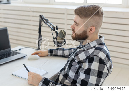 technology, home, music and lifestyle concept - smiling man with laptop and headphones at home 54909495