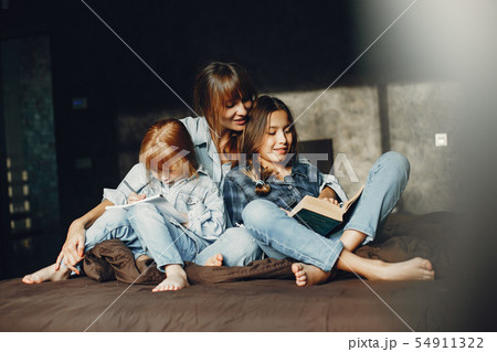 Mother with daughters at home Mother with daughters at home 54911322