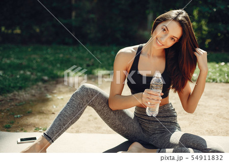 Beautiful sports girl in a summer park Beautiful sports girl in a summer park 54911832